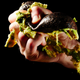 A hand gripping an avocado with force, unconnected to the Twitter account
